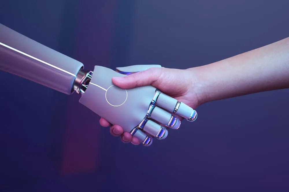 Uścisk dłoni pomiędzy robotem a człowiekiem